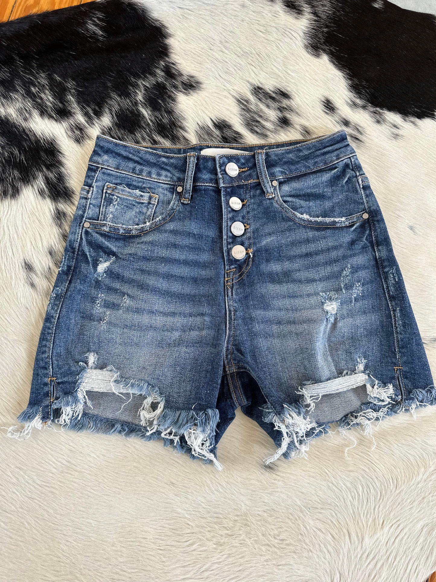 The High Rise Medium Wash Ripped Shorts