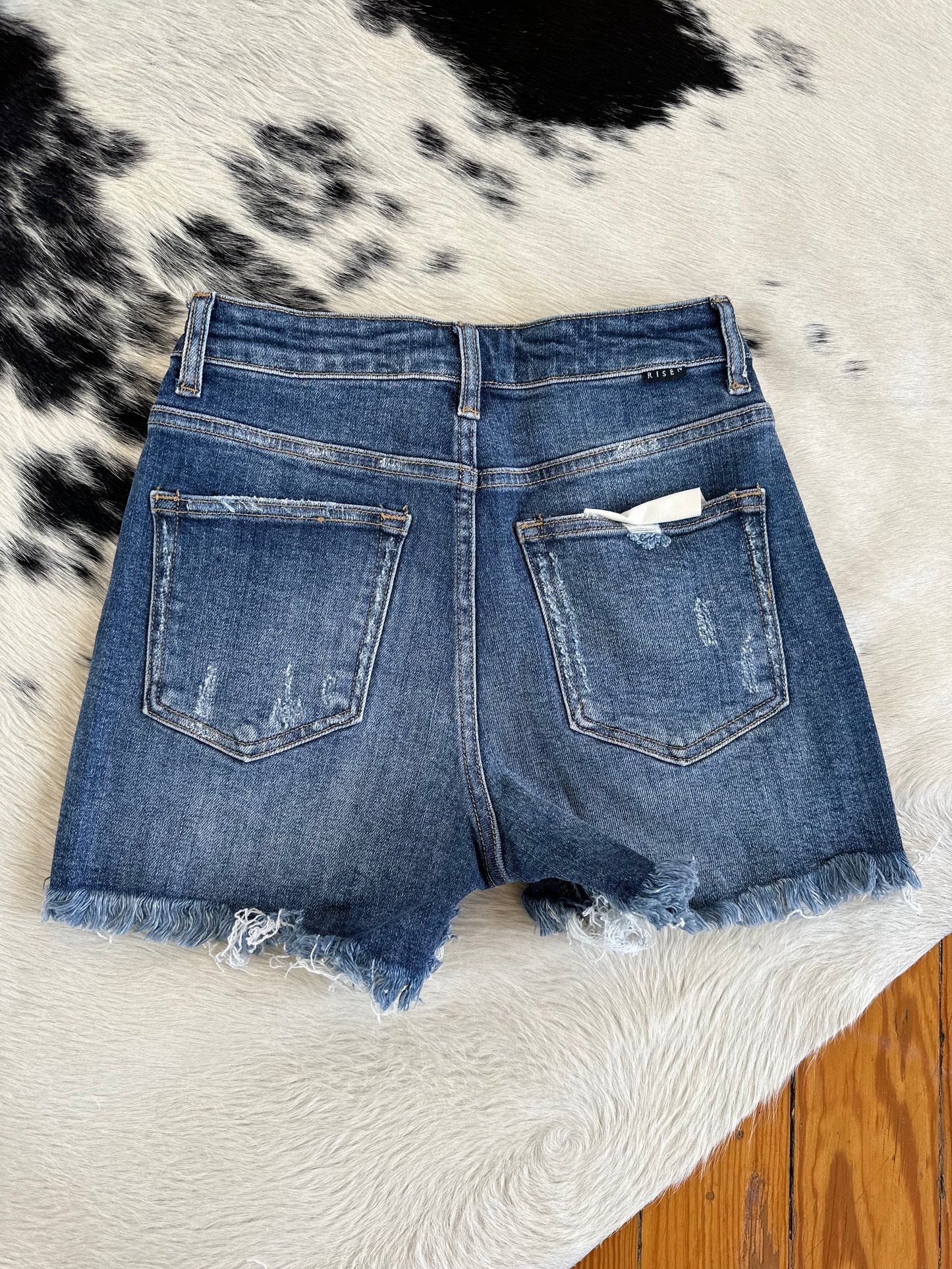 The High Rise Medium Wash Ripped Shorts